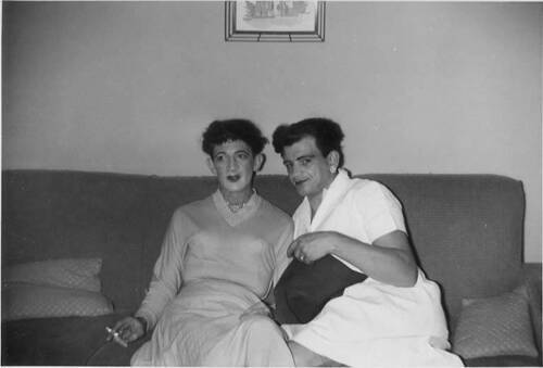 Download the full-sized image of Two unknown femmes smoking together on a couch