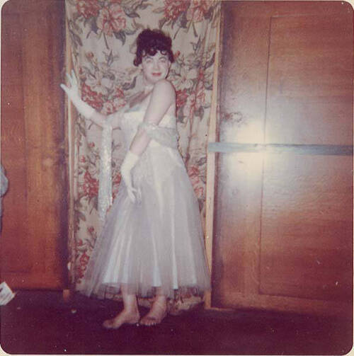 Download the full-sized image of Unknown femme in white dress posing in front of a curtain