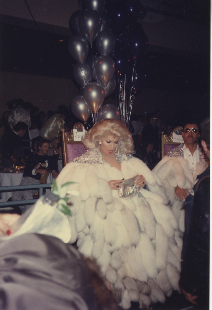 Download the full-sized image of Photograph of Person Sitting with Large White Fur Coat