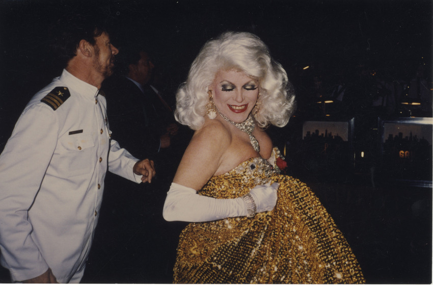 Download the full-sized image of Photograph of Person in Drag with Gold Sparkly Dress and Platinum Hair