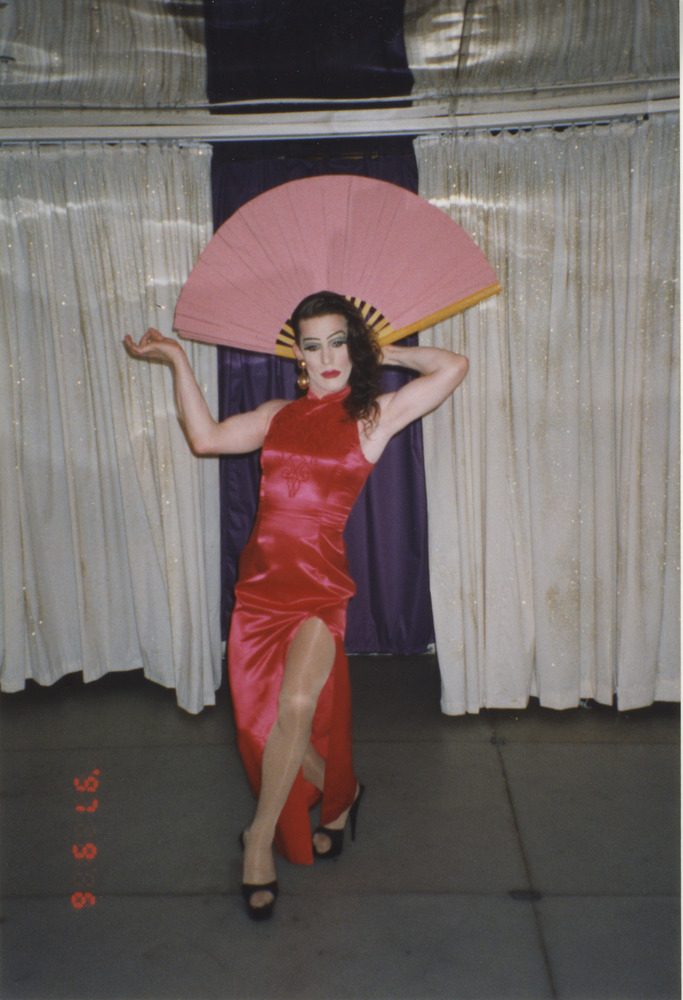 Download the full-sized image of Photograph of Person in Red Dress with Fan