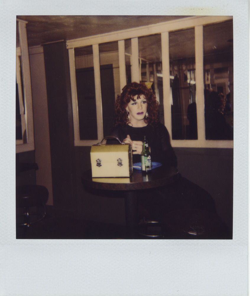 Download the full-sized image of Photograph of Person in a Black Dress Sitting at a Table