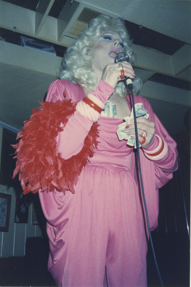 Download the full-sized image of Photograph of Alexis Francois in Pink Jumpsuit Singing