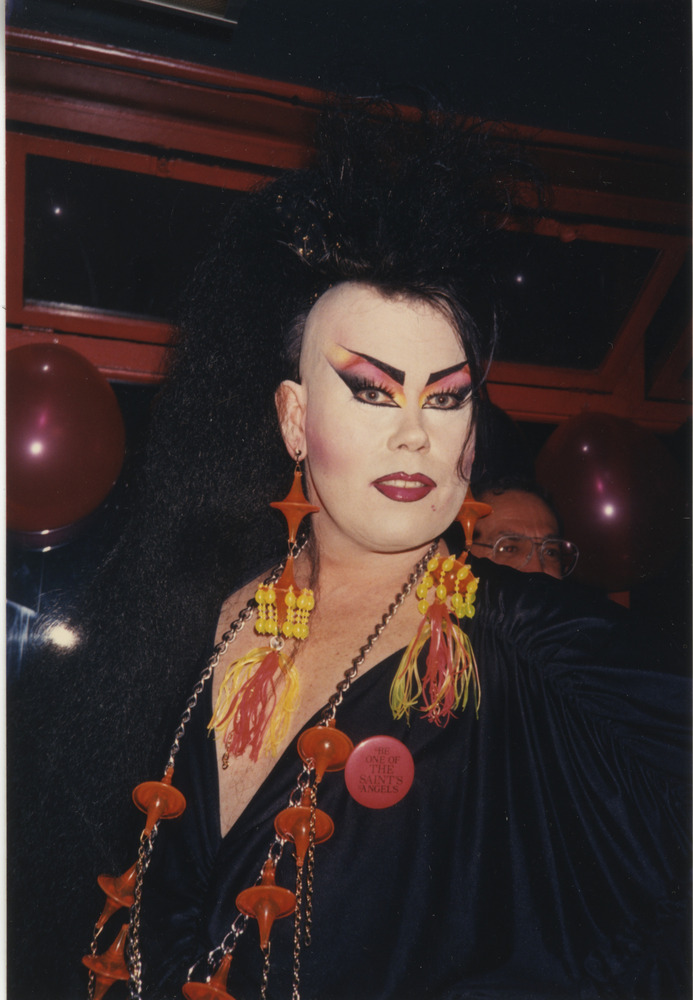 Download the full-sized image of Photograph of Person in Black Dress and Black Mohawk Hairstyle