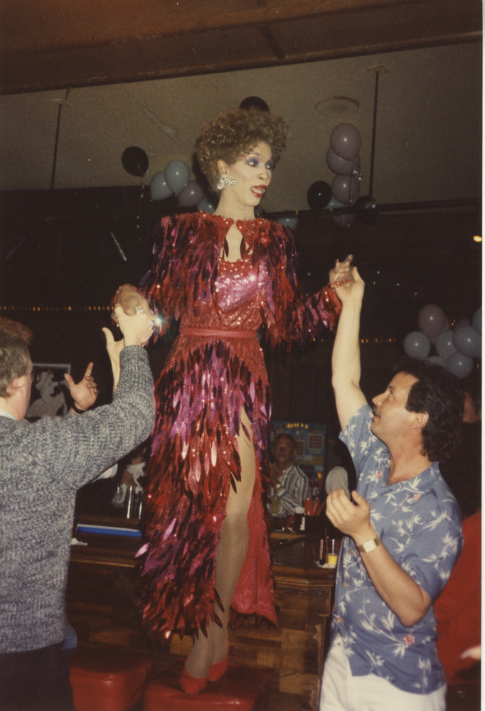 Download the full-sized image of Photograph of Person in Drag with Sparkly Red Dress and Jacket