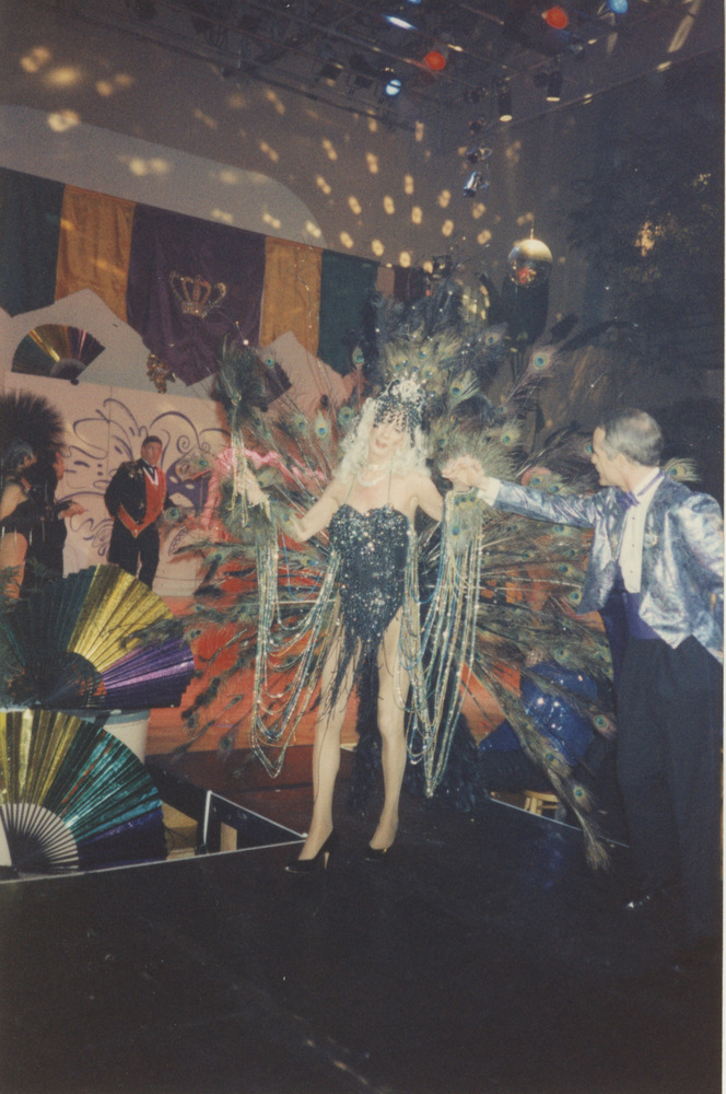 Download the full-sized image of Photograph of Person in Black Bodysuit with Peacock Feathers