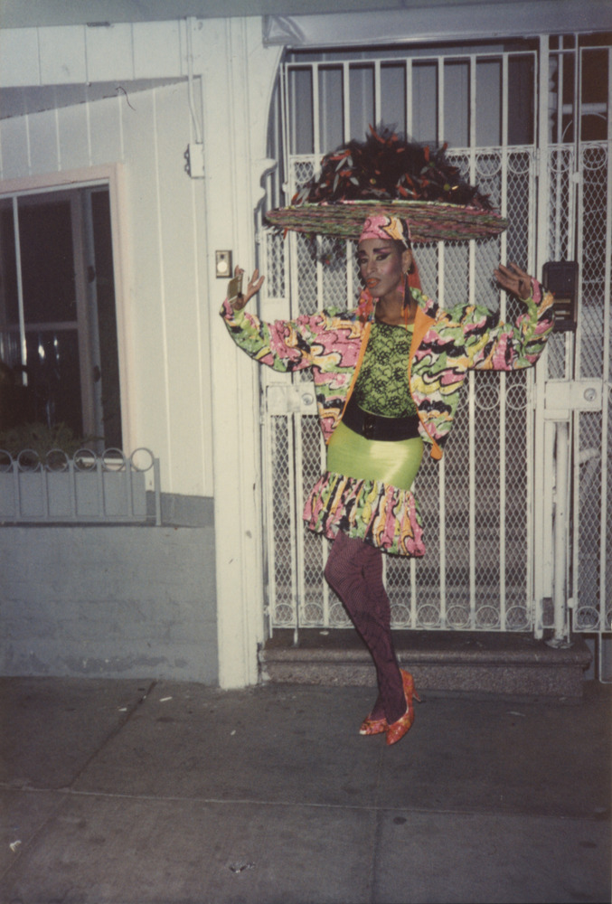 Download the full-sized image of Photograph of Person in Short Green Dress and Multicolor Headpiece