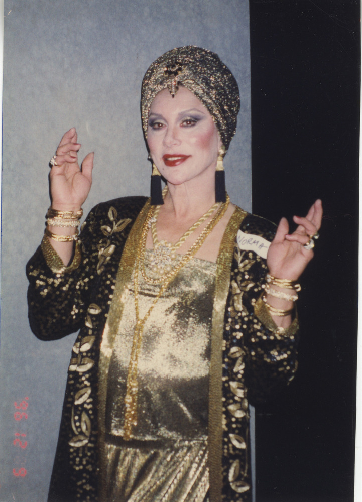 Download the full-sized image of Photograph of Alexis Francois in Gold Shimmery Outfit with "Norma" Nametag