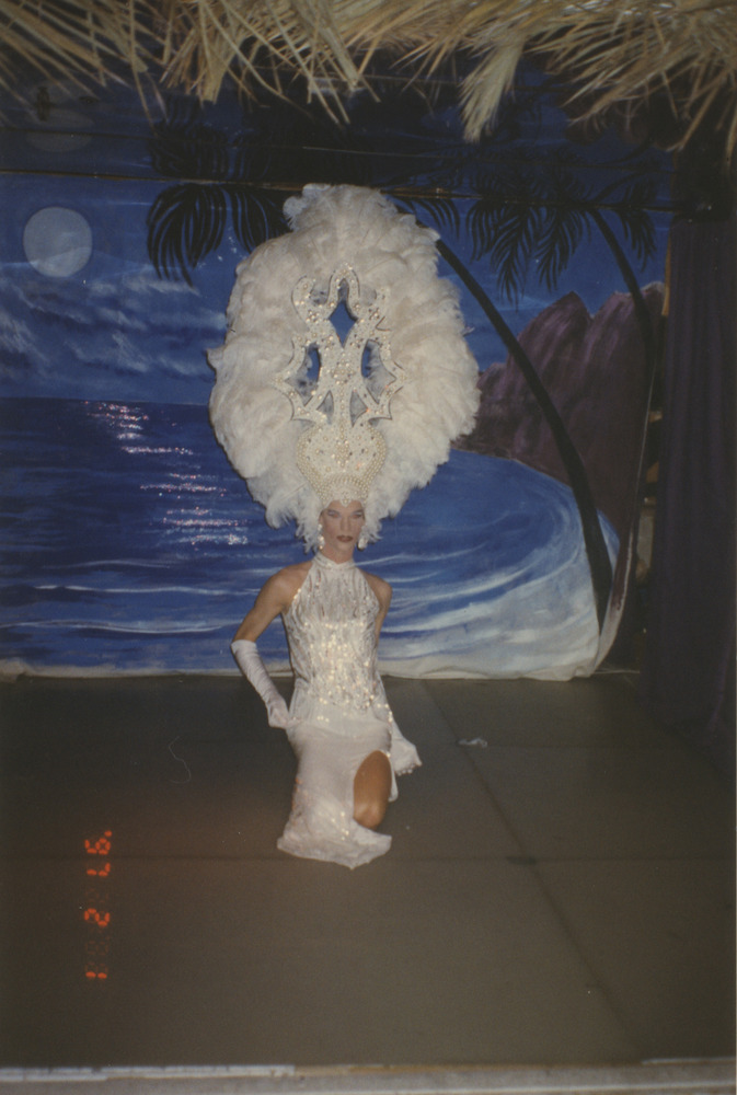 Download the full-sized image of Photograph of Person in Tall White Feathered Headpiece