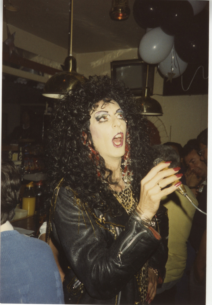 Download the full-sized image of Photograph of Person in Leather Jacket Holding a Microphone