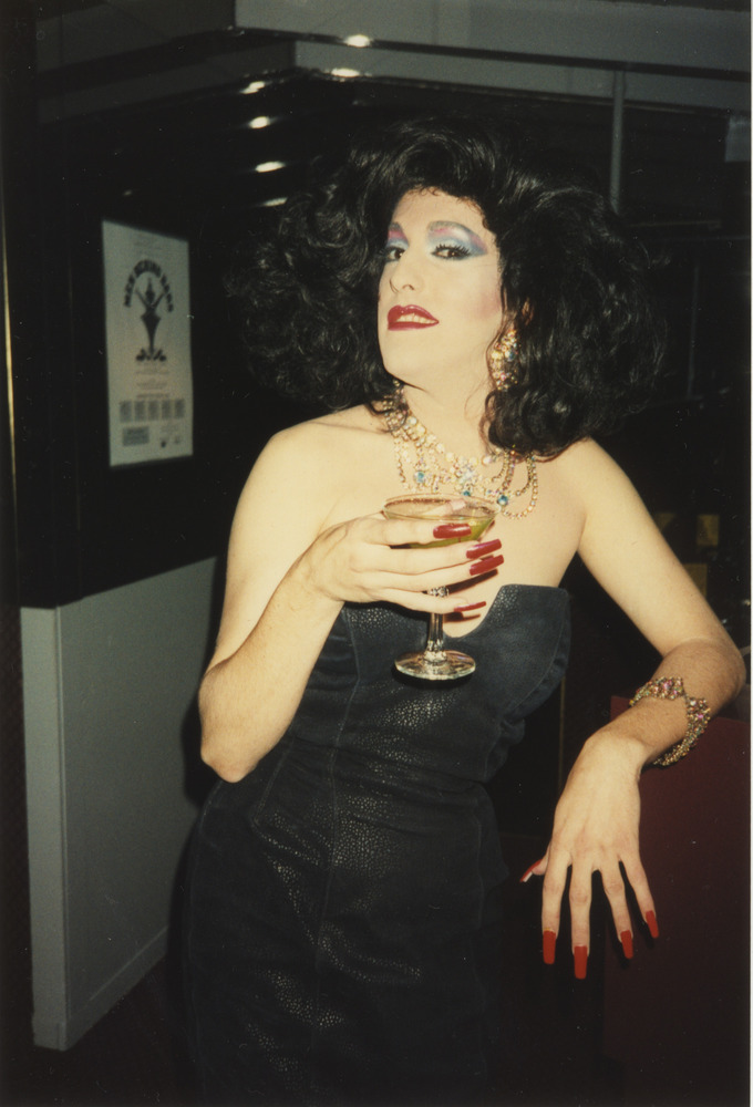 Download the full-sized image of Photograph of Person in Black Dress Holding a Drink