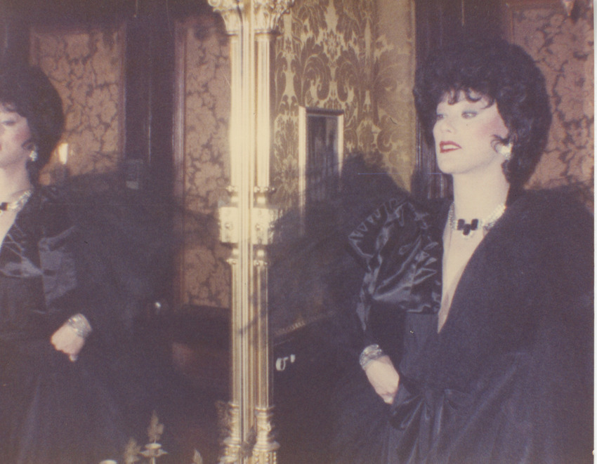 Download the full-sized image of Photograph of Alexis Francois in a Black Gown Standing by a Mirror