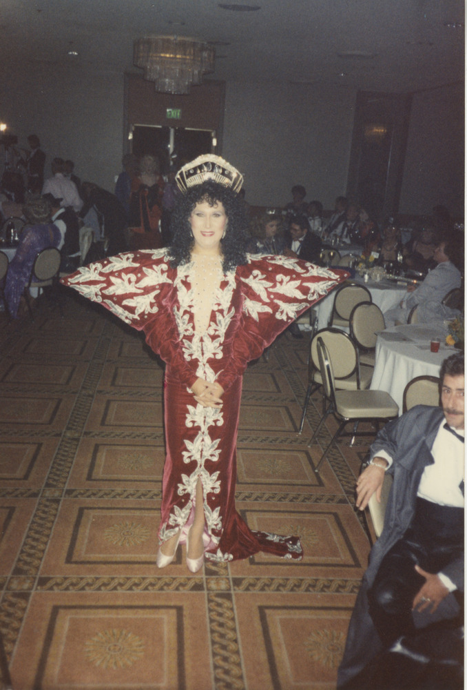 Download the full-sized image of Photograph of Person in Red and White Dress with Shoulder Pads