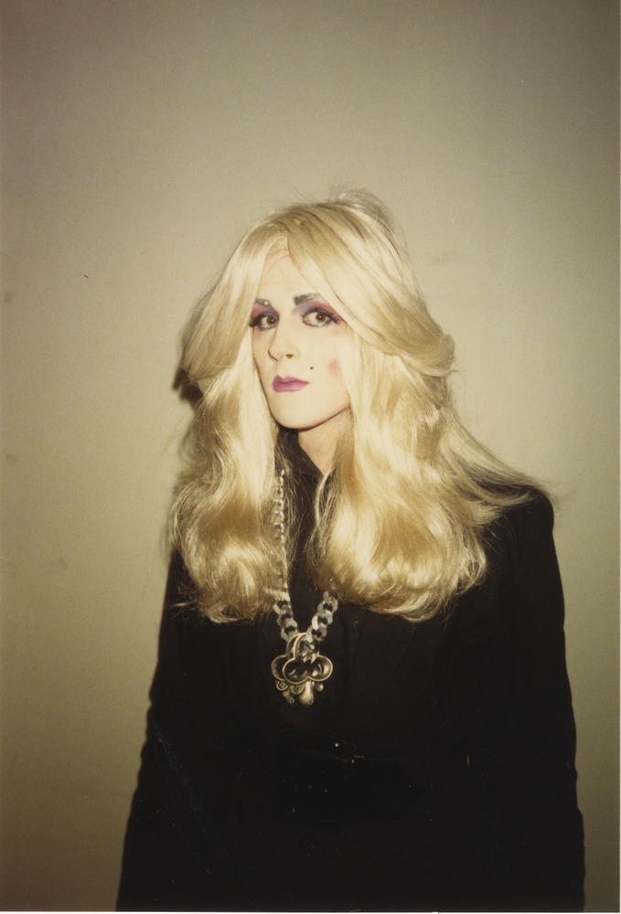 Download the full-sized image of Photograph of Person in Black Outfit and Blonde Wig