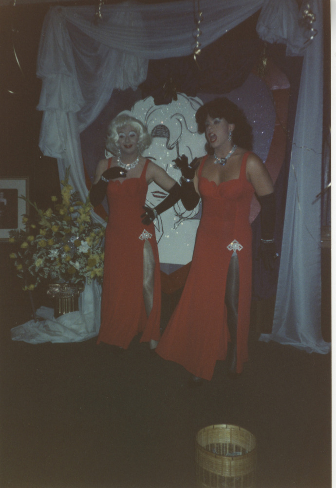 Download the full-sized image of Photograph of Two People in Matching Red Dresses