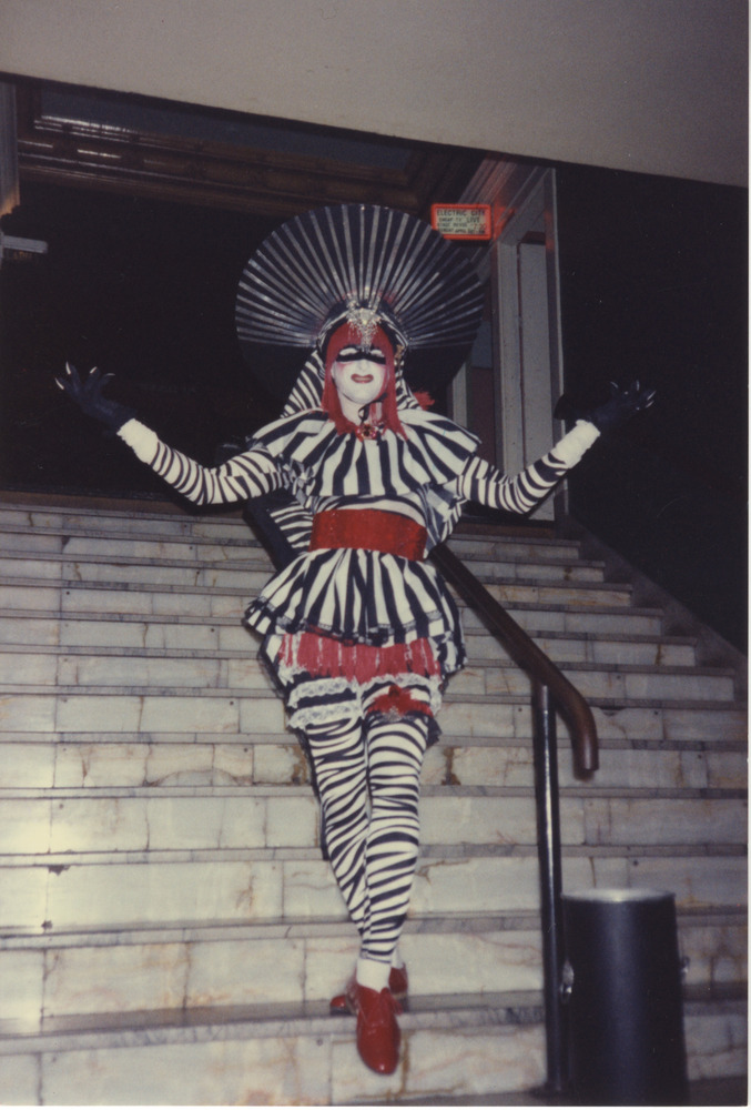 Download the full-sized image of Photograph of Person in White and Black Striped Costume with Red Shoes