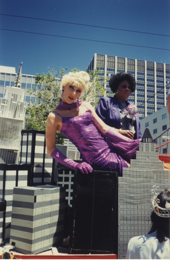 Download the full-sized image of Photograph of People on Parade Float with Cityscape