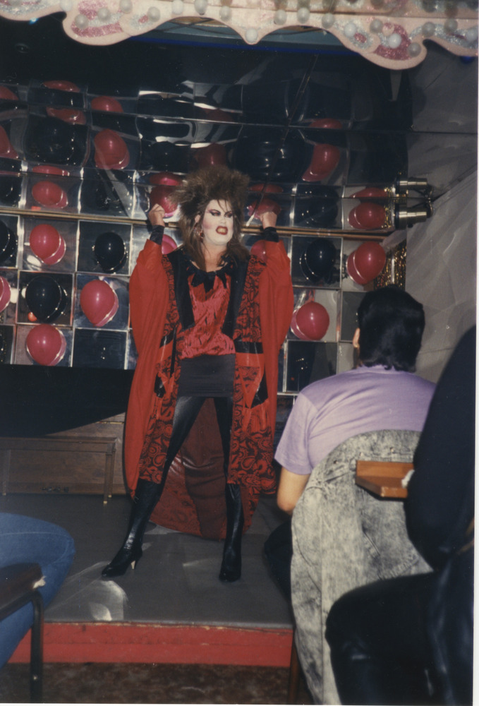 Download the full-sized image of Photograph of Person in Red Mini Dress and Cape